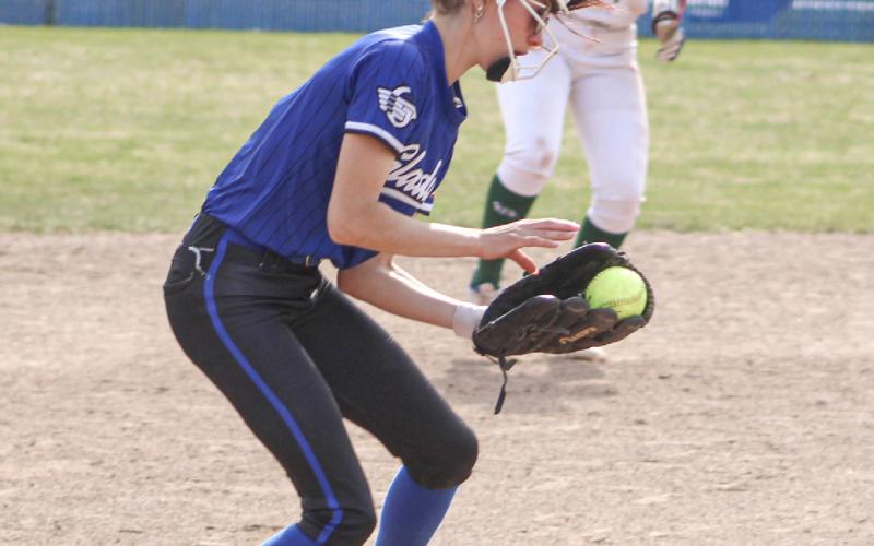 Austin McCormack digs up a ground ball at third base for the Gladwin softball team during a game earlier this season.