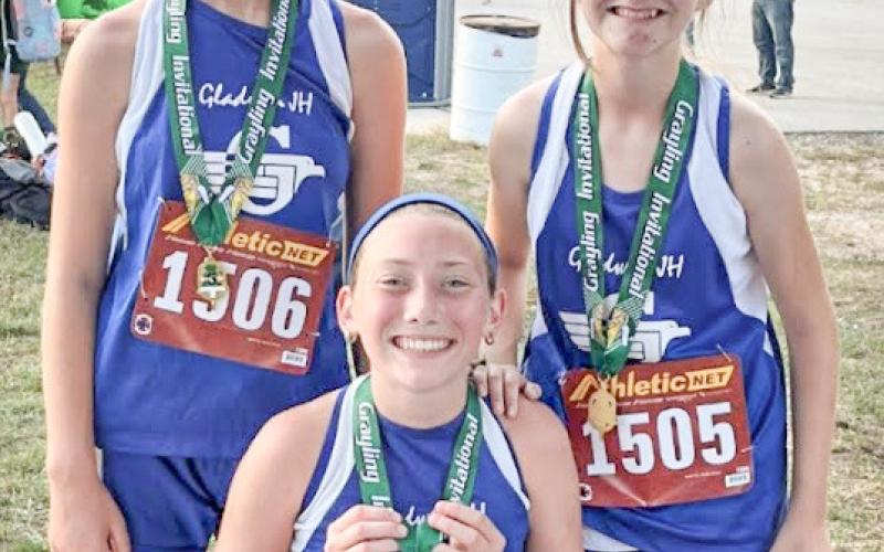 Chloe Johnson, Vada Povey, and Izzy Hurst with their medals from the Grayling Invitational.