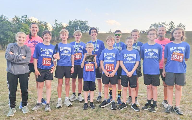 The junior high boys team with their first place plaque at the Grayling Invitational.