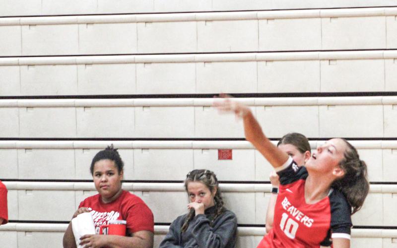 Beaverton’s Piper Carland serves up an ace last Wednesday night as the Beavers took two matches out of three in a quadrangular meet.