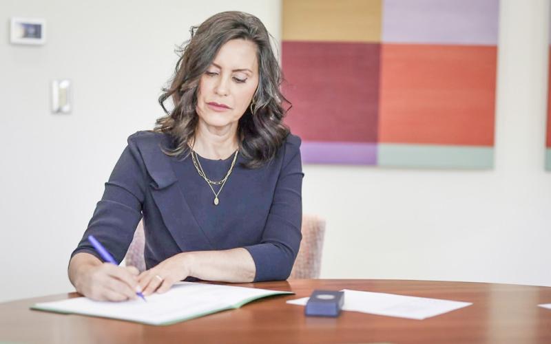 Governor Whitmer is pictured signing six commonsense bills into law.