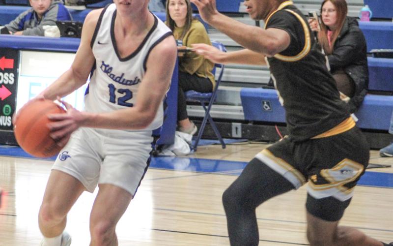 Gladwin’s Jacob Pahl looks inside for an open teammate during Thursday night’s impressive victory over visiting Ogemaw Heights.