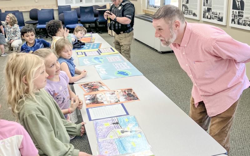Beaverton Elementary School Teacher Matt Collins guided his first graders through a public display of learning Monday at the Beaverton Activity Center.