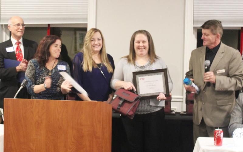 Pictured is Jennifer Sheldon accepting her award, with (starting at left) Legislative Aide Joel Johnson from Congressman John Moolenaar’s office, Karen Moore, Gladwin County, Michigan Works! Region 7B Gladwin County Career Advisor Suzanne Sundberg, Jennifer Sheldon, and Michigan Works! Region 7B Executive Director Mark L. Berdan looking on.