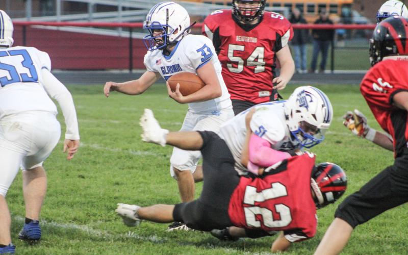 Gladwin’s Max Barz blocks Beaverton’s Nate Diamond to create running room for Ryan Quick during the Flying G’s junior varsity victory. BEAVERTON