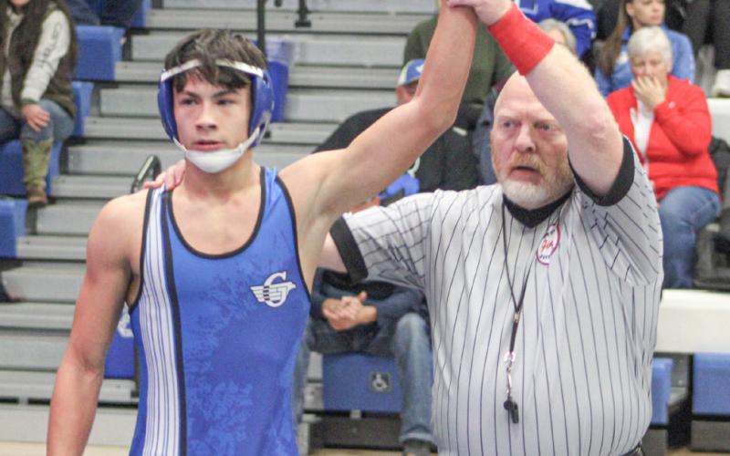 Cruz Balcirak is declared the winner Wednesday night while helping Gladwin to a pair of Jack Pine Conference dual meet victories.
