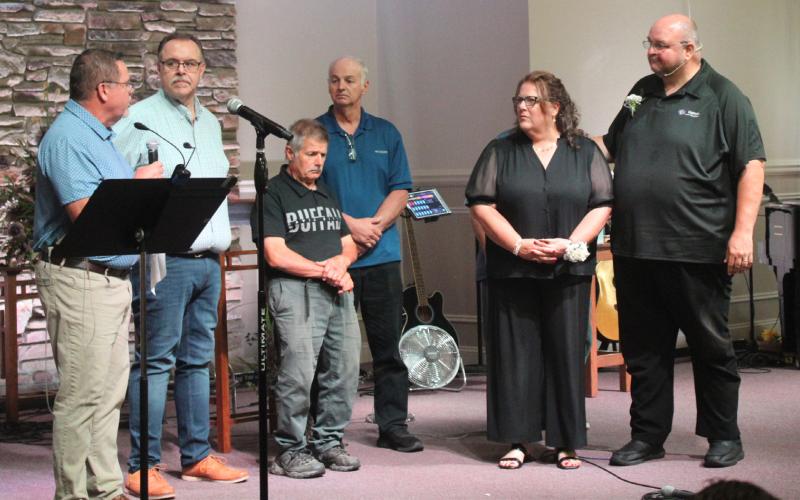 Gladwin Assembly of God officials pay tribute to Pastor Brad Withrow and his wife, Cheryl, during Sunday’s celebration of Withrow’s 32 years as a pastor at the church.