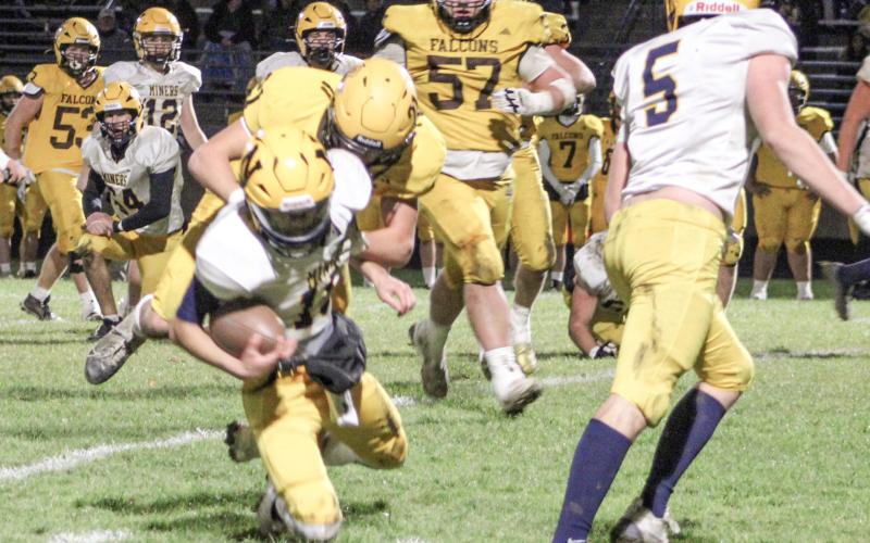 Ogemaw Heights’ Jackson Ziegler crushes the quarterback for a sack during Friday night’s overtime victory over Negaunee in the first round of the Division 5 playoffs.