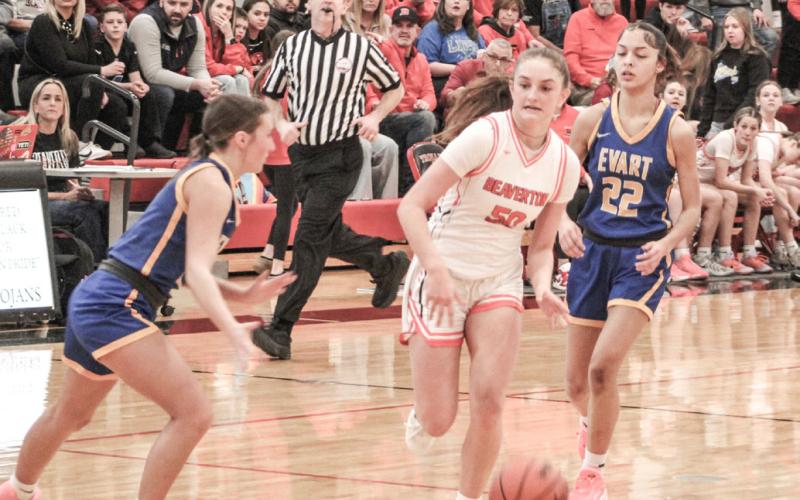 Beaverton’s Myah Hubble tries to navigate her way between two Evart defenders during Monday night’s game at Lake City.
