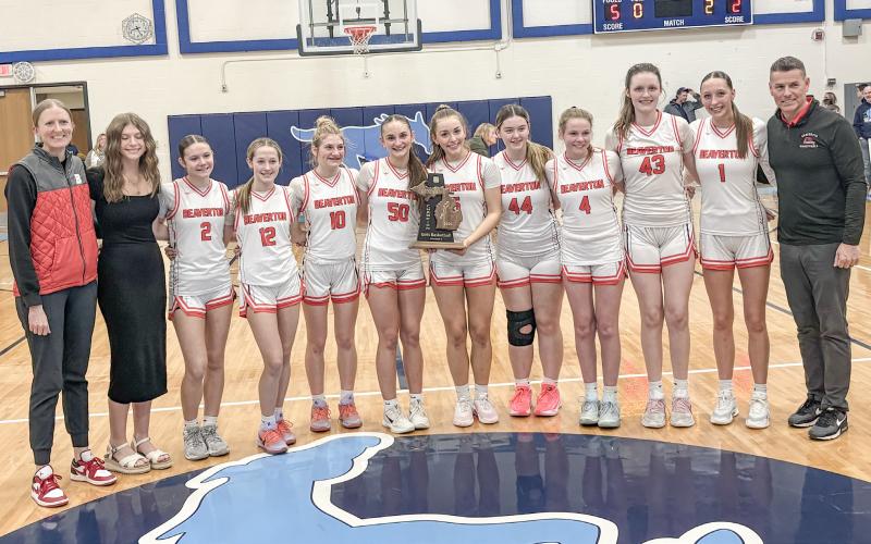 Beaverton’s girls’ basketball team shows off the trophy after winning the Division 3 district championship Friday night at Meridian with a win over the host Mustangs.