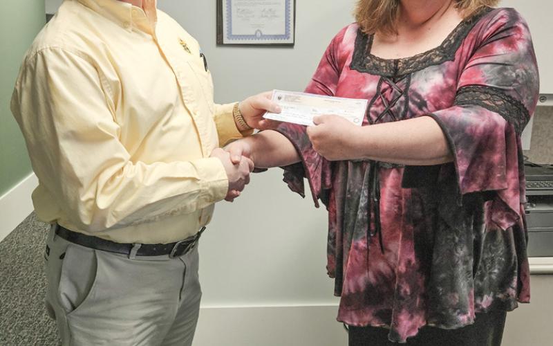 Tom Fruchey presents check to Jennifer Bell of the Arnold Center.