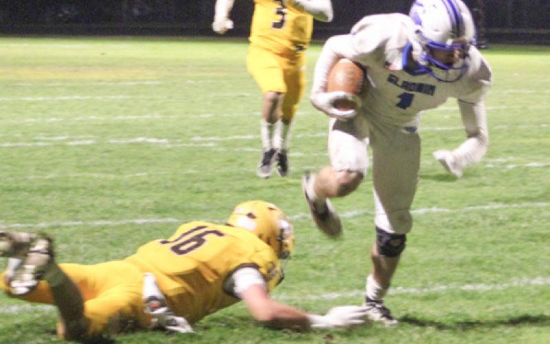 Gladwin’s Trace Corlew steps out of his tackle on his way to a punt return touchdown Friday night at Ogemaw Heights.