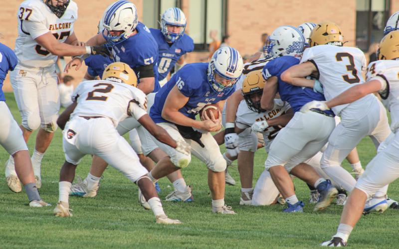 Ogemaw Heights’ Elijah Smith gets into position to tackle Gladwin quarterback Colton Pfenninger during Friday night’s victory for the Falcons. COURTNEY VERELLEN