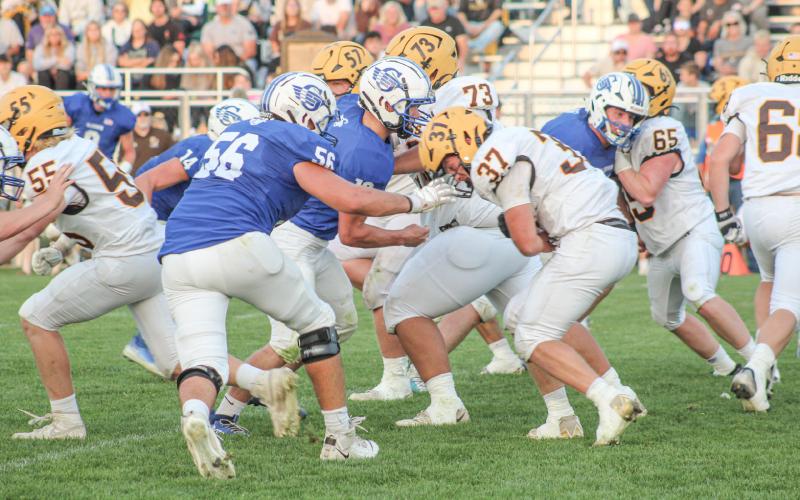 Ogemaw Heights’ Calvin Marshall and Gladwin’s Harvey Grove battle it out in the trenches Friday night in the Jack Pine Conference opener. COURTNEY VERELLEN