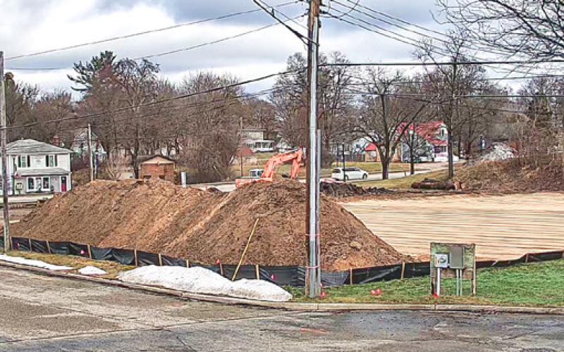 The removal of the Marathon gas pumps at Next Door Store is complete and the stage is set for expansion of the Riverwalk Place parking lot.