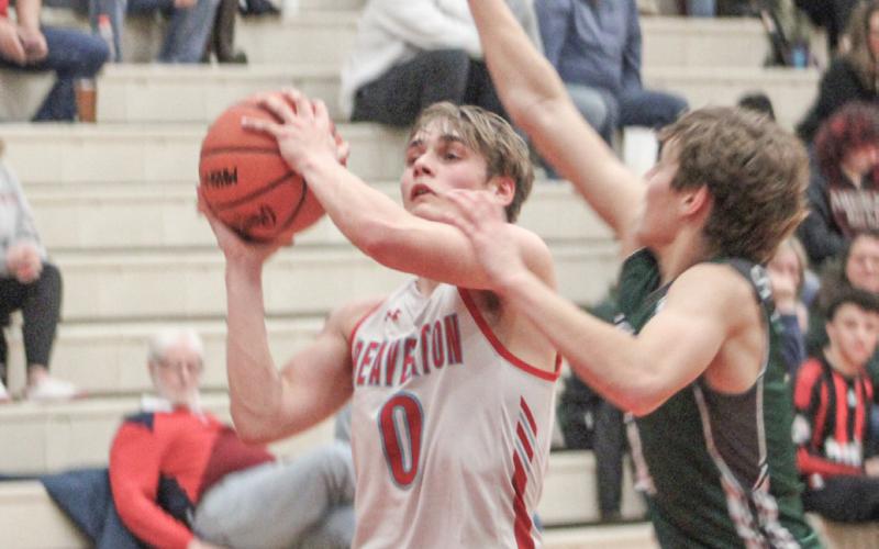 Beaverton’s Caiden Loar takes the contact on a drive to the basket during last week’s district semifinal loss to Pinconning.
