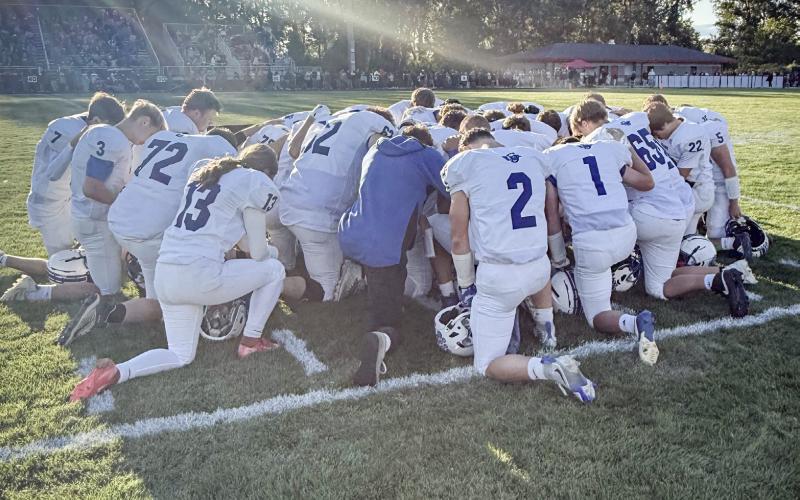 The Gladwin football team circles up on the field prior to Friday night’s game at Spring Lake, where the locals fell to 0-2 on the young season.