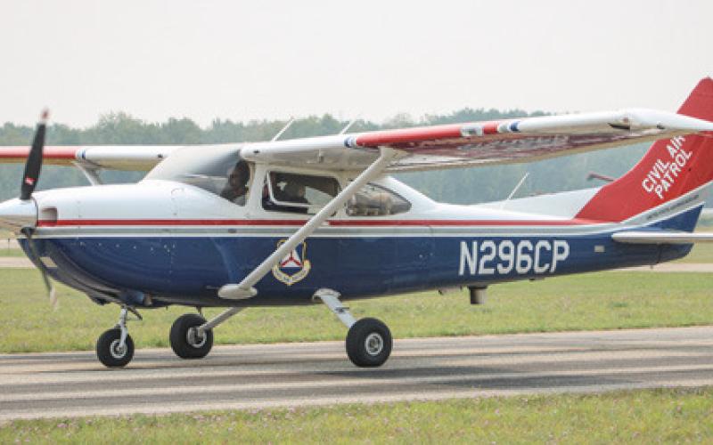 Volunteer victims of a simulated natural disaster were checked in and issued cots Saturday at the Fairgrounds during a training exercise that involved the Michigan Wing of the Civil Air Patrol (plane inset), Gladwin County Emergency Management and several other local emergency agencies.