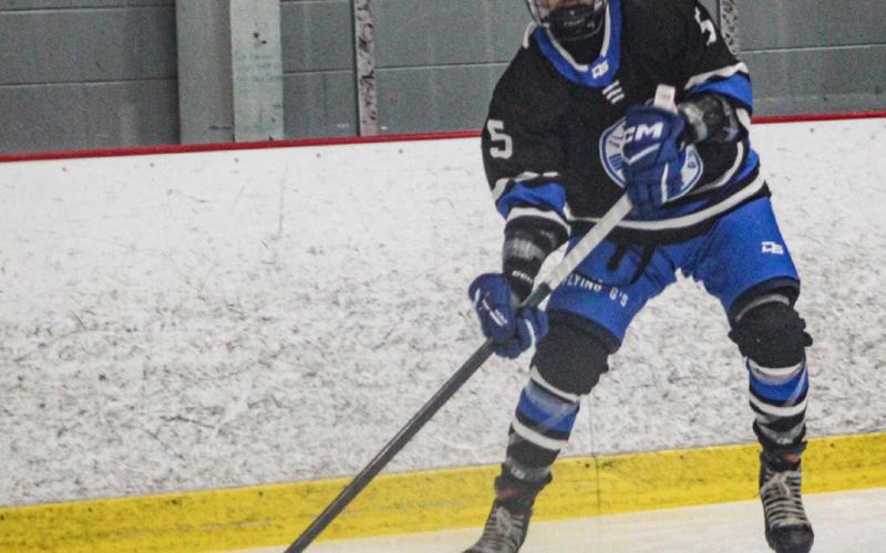 Gladwin’s Caden McKeever sends a pass toward the front of the net during a recent game.