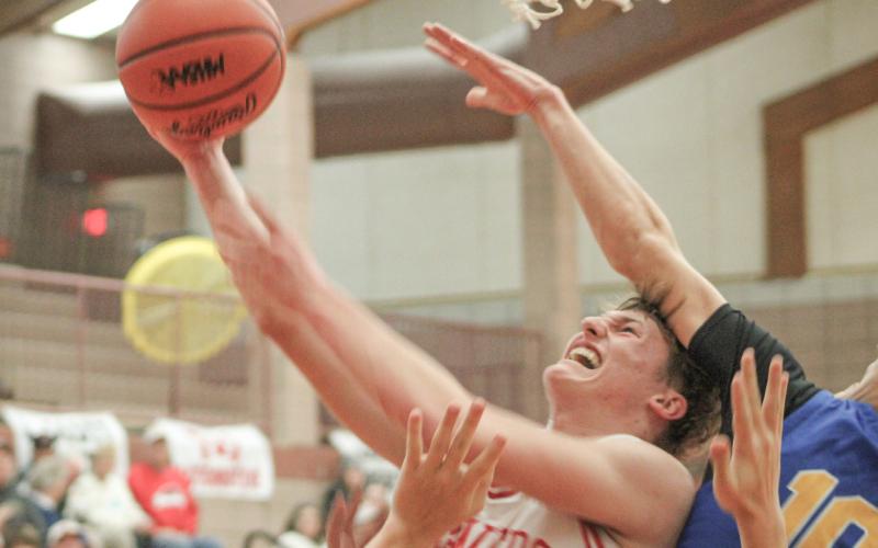 Beaverton’s Ian Roberts takes the heat on the way to the hoop Friday night in a 74-43 victory over visiting Harrison.