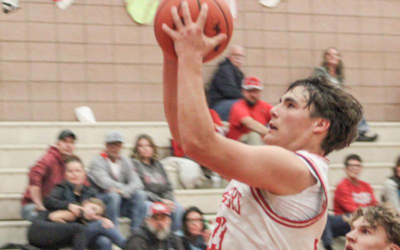 Beaverton’s Landon Love drives to the basket for two of his game-high 34 points in Friday night’s victory over Harrison.