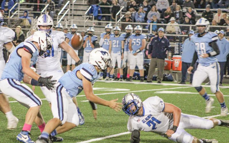 Gladwin’s Matthew Lechner forces a fumble up into the air that was eventually recovered by Kaden Reid during Friday night’s victory at Meridian.