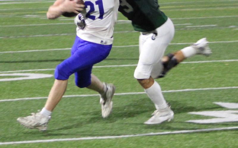 Gladwin’s Talan Goodwin tries to break free from Clare’s Brody Allen during Friday night’s game.