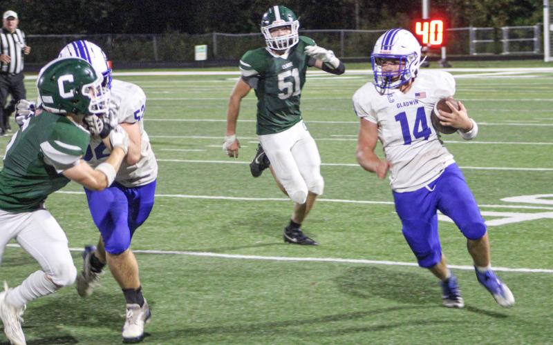 Gladwin’s Preston Willert looks for running room during Friday night’s 28-26 victory at Clare.