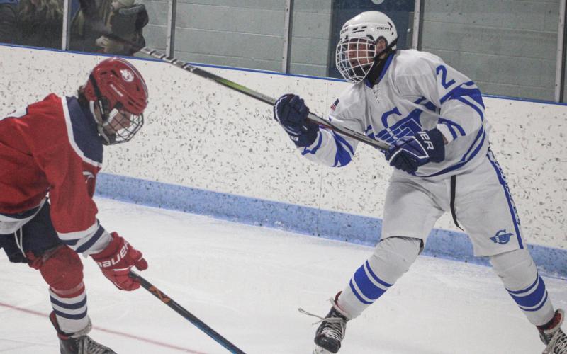 Trinity Hair flips the puck toward the slot during Gladwin’s overtime victory over the Genesee Generals.