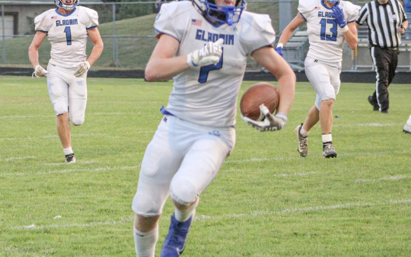 Gladwin wide receiver Bronson Bigham heads for the open field during a game at Ogemaw Heights last season.