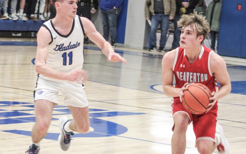 Gladwin’s Trace Corlew closes in on Beaverton’s Caiden Loar during last Tuesday night’s victory for the Flying G’s.