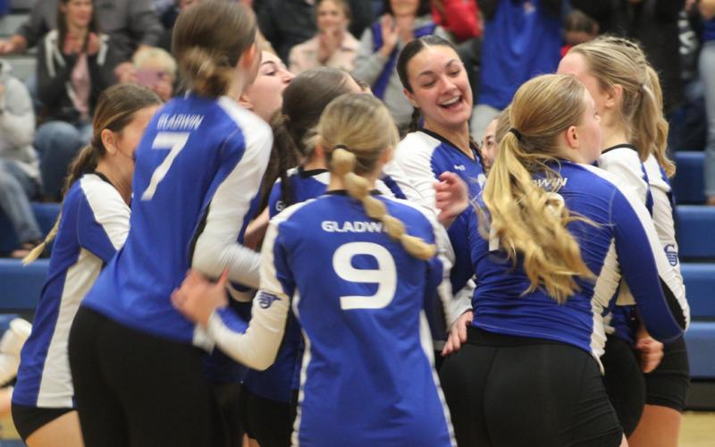 Gladwin’s volleyball team whoops it up after knocking off Clare in the district semifinals last Wedensday night.