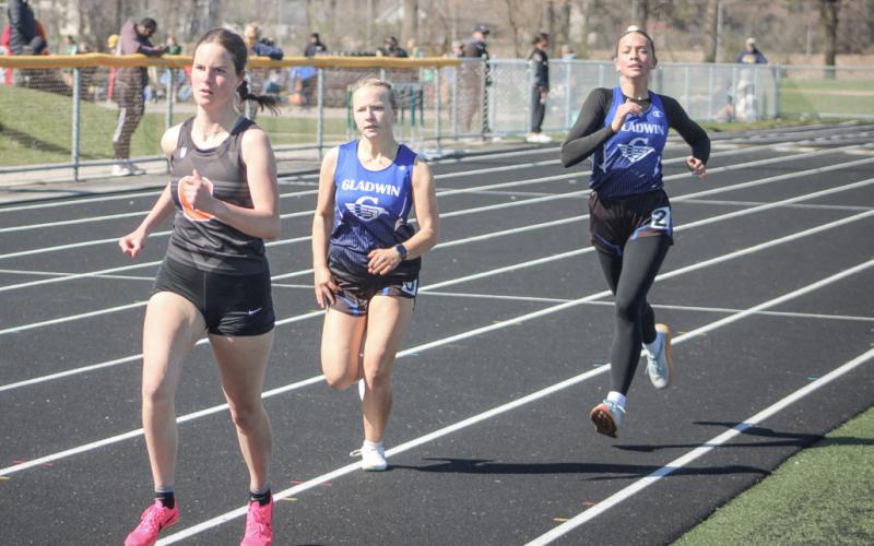 Gladwin’s Jewelia Anderson (left) and Callie Mead push each other toward the finish line during a recent race.