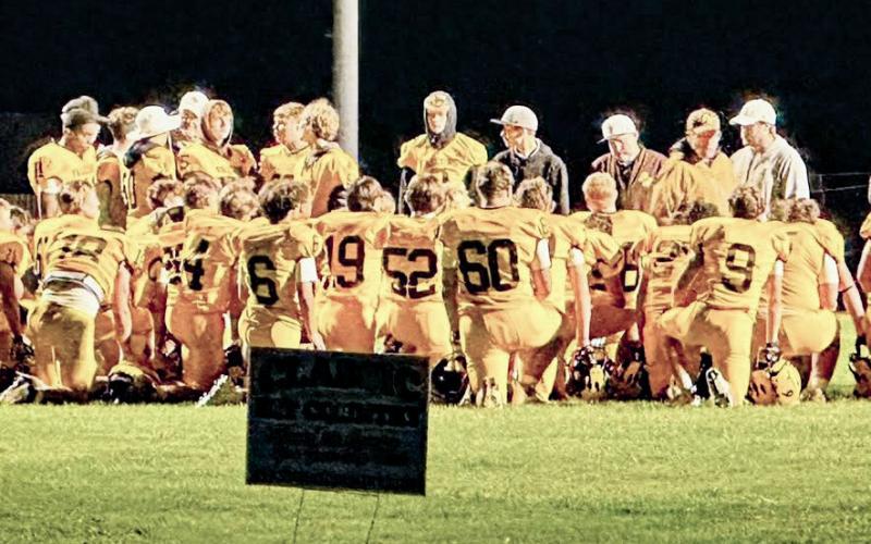 The Ogemaw Heights football team hears words of encouragement after Friday night’s loss to Traverse City St. Francis.