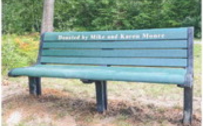 Pictured above are two of the three benches that were installed by, pictured at left, Mike Moore and Tristan Hewitt.
