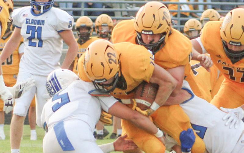Returning Ogemaw Heights senior running back Connor Lambert draws a crowd during last year’s match-up with Gladwin.