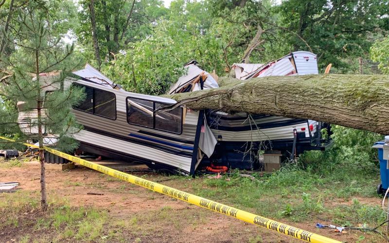 Tree falls onto camper trapping occupant
