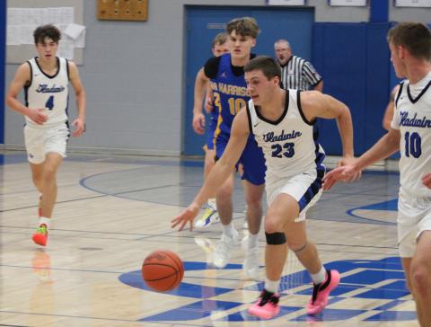 Colton Pfenninger runs the floor during Gladwin’s 67-47 victory over Harrison in the home opener on Friday night.