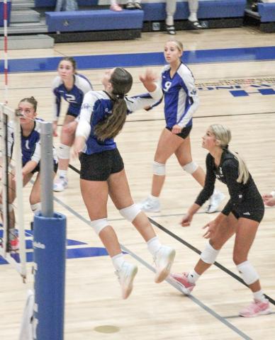 Gladwin’s big hitter Ansley Mausolf gets up and at ‘em during last Wednesday night’s impressive threeset victory over Ogemaw Heights.