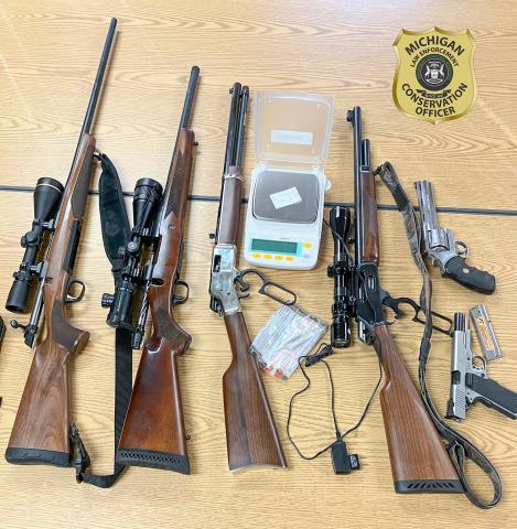 Michigan DNR conservation officers seized 2 grams of cocaine, two pistols and four rifles, from three Oakland County men in two separate vehicles, located north of Atlanta, on Nov. 15.