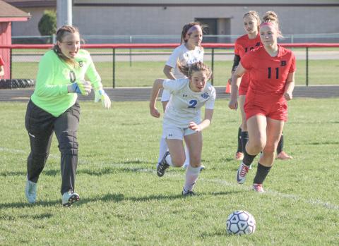 Beaverton goalie Anna Mannigel, Gladwin’s Vivian O’Callaghan and Beaverton’s Caroline Ogendahl converge on the ball in the box during Gladwin’s victory Thursday.