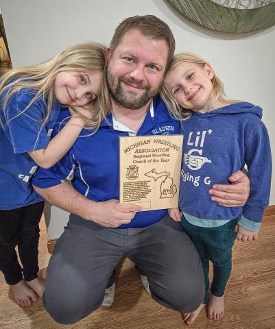 Gladwin’s Buddy Goldsworthy and two of his biggest fans celebrate his being named Regional Coach of the Year.