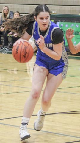 Laura Elorriaga lowers her shoulder and heads toward the basket during Monday night’s loss to Ogemaw Heights in the first round of the districts at Clare.