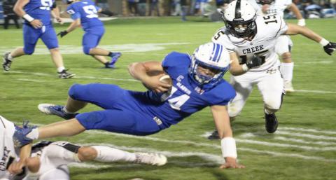 Gladwin’s Preston Willert lunges forward for an extra yard during Friday night’s 50-30 Homecoming victory over Bullock Creek.