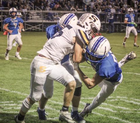 Gladwin’s Preston Willert and Drake Ross team up for a crunching tackle during Friday night’s Homecoming victory over Shepherd.