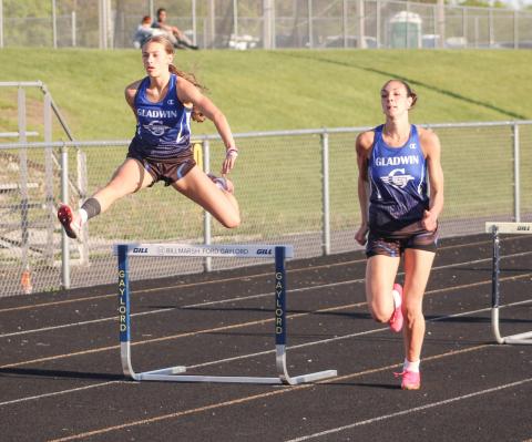 Gladwin’s Bree Visser takes flight as two-time All-State teammate Ava Gary picks up steam during the 300 hurdles at the Northern Michigan Meet of Champions last Tuesday.