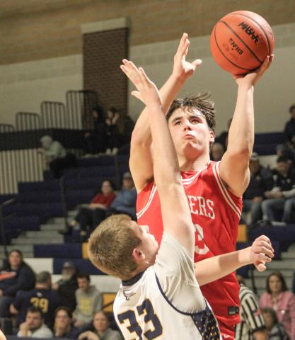 Beaverton’s Landon Love goes up and over a Shepherd defender during a victory Thursday night that clinched the Jack Pine Conference Division 2 title for the Beavers.