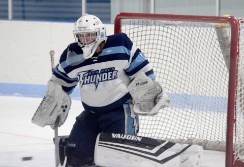 Trenton Reid defends the net against Bishop-Foley.