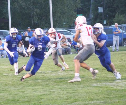 Gladwin’s Bronson Bigham looks for running room during Gladwin’s loss to Spring Lake Thursday night.