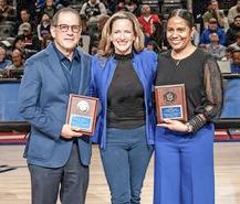 Detroit Pistons Vice Chair Arn Tellem, Secretary Benson and Erika Swilley, vice president of community and social responsibility for the Detroit Pistons at center court.